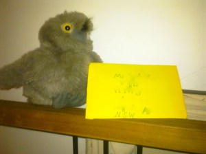 Photo of a toy owl delivering a yellow envelope.